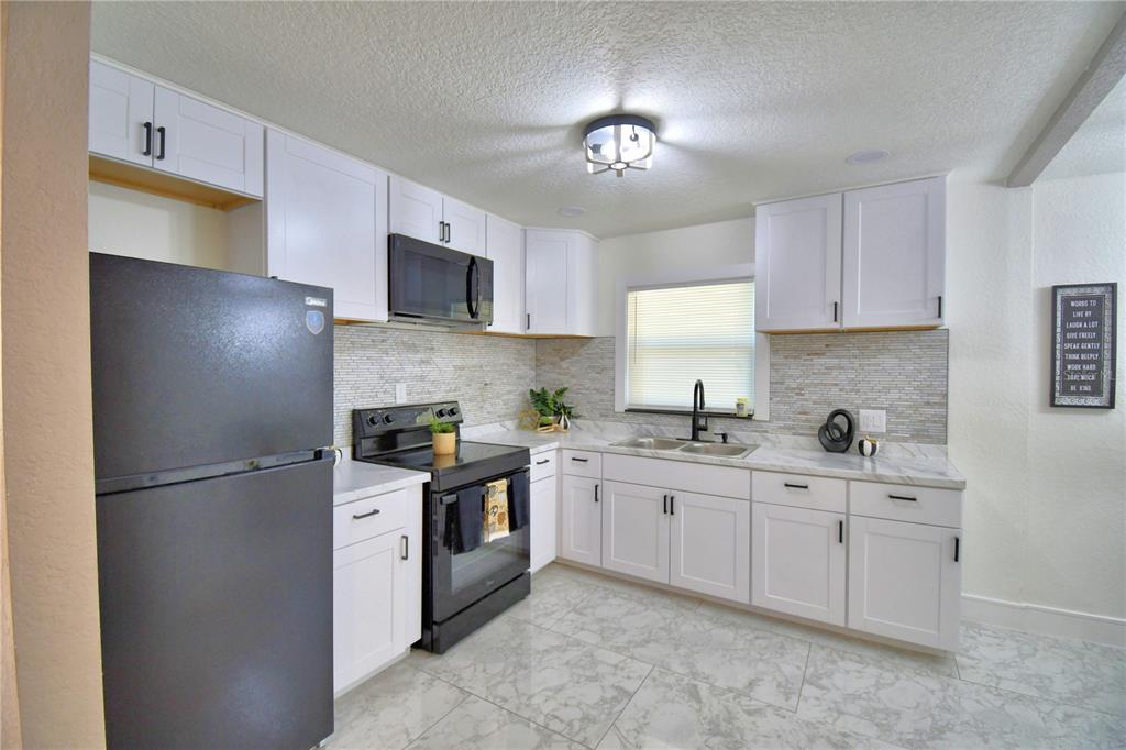 6960 2nd Street Mulberry, FL 33860 - Photo 18 of 39 a kitchen with stainless steel appliances granite countertop a refrigerator sink and cabinets