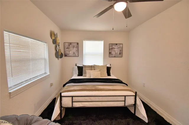 a bed sitting in a bedroom next to a window