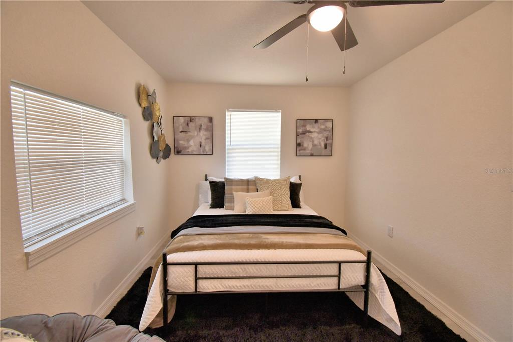 6960 2nd Street Mulberry, FL 33860 - Photo 19 of 39 a bed sitting in a bedroom next to a window