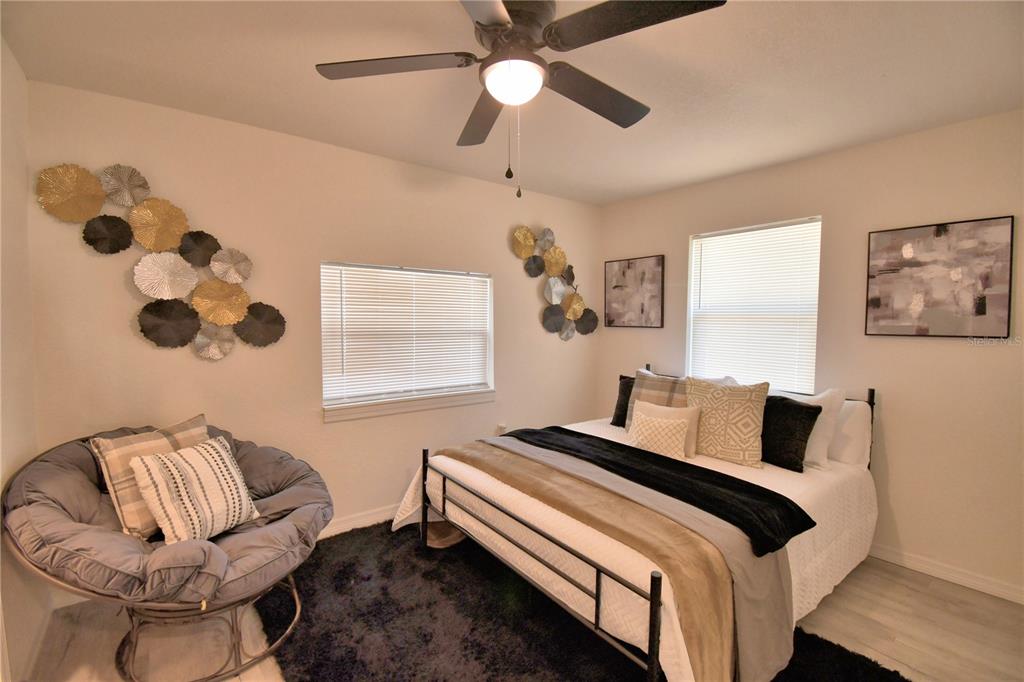 6960 2nd Street Mulberry, FL 33860 - Photo 22 of 39 a bedroom with a bed and a chandelier