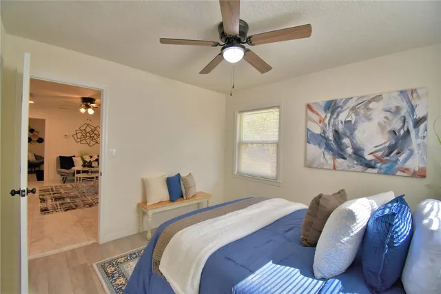 a bedroom with a bed and a painting on the wall