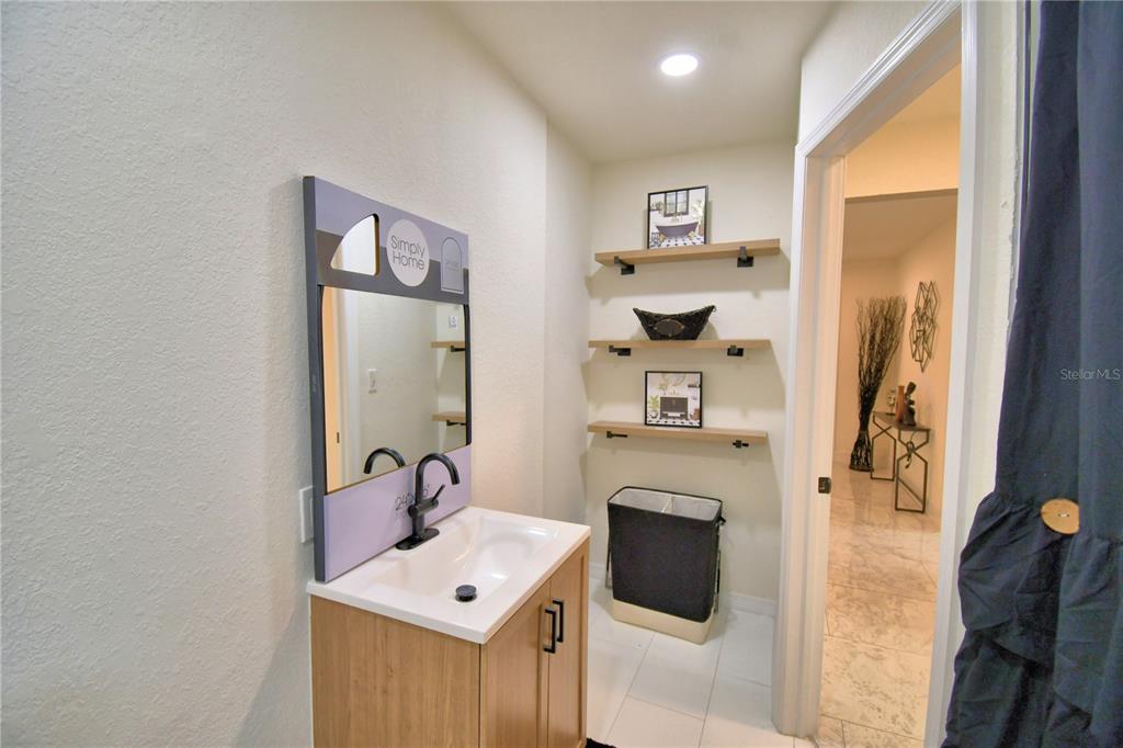 6960 2nd Street Mulberry, FL 33860 - Photo 27 of 39 a bathroom with a sink a toilet and shower