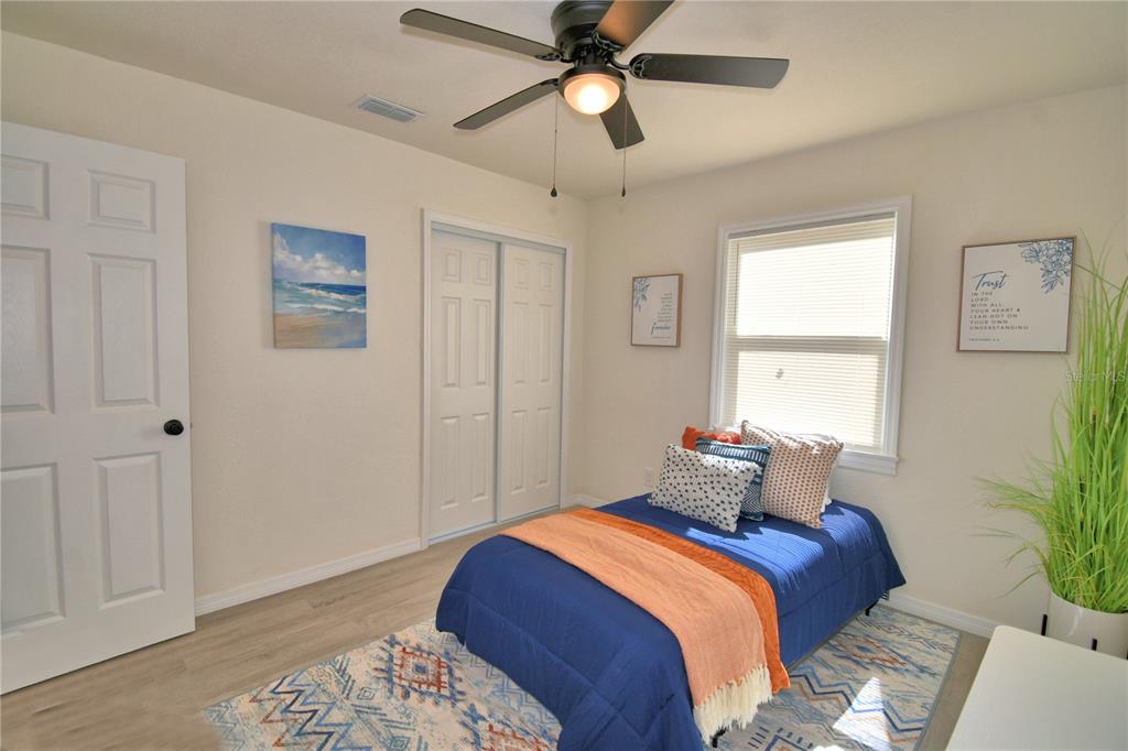 6960 2nd Street Mulberry, FL 33860 - Photo 36 of 39 a bedroom with a bed and a potted plant