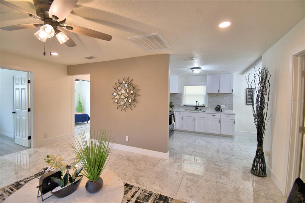 6960 2nd Street Mulberry, FL 33860 - Photo 7 of 39 a kitchen with stainless steel appliances a refrigerator sink and cabinets