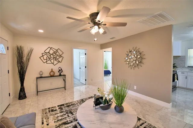 a living room with furniture and potted plant