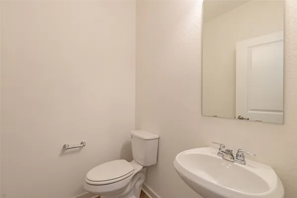 a kitchen with stainless steel appliances granite countertop a sink a stove and a wooden floors
