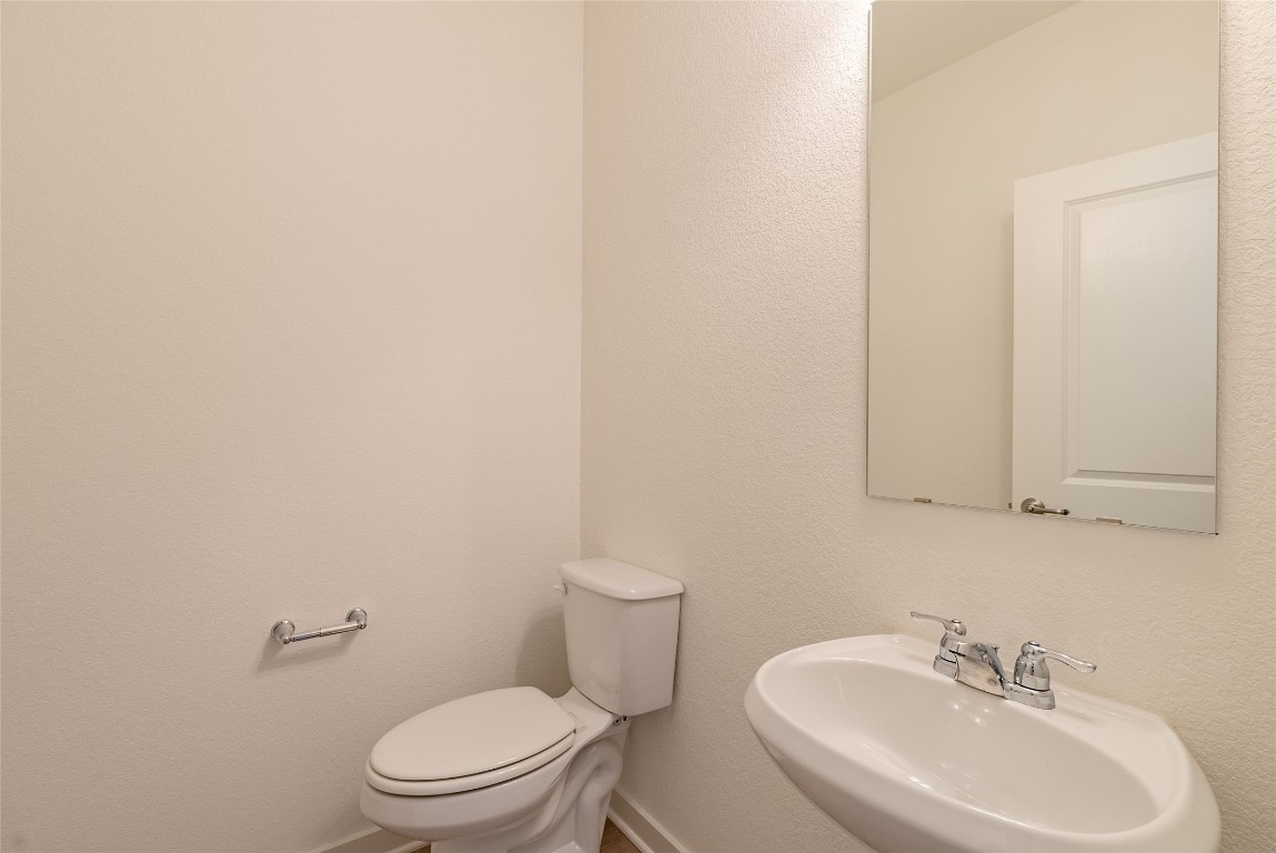 7400 Sparkling Light Drive, Unit A Del Valle, TX 78617 - Photo 8 of 22 Half bathroom with a textured wall and a sink