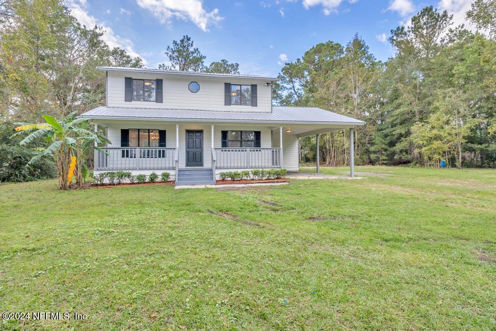 54197 Jeannie Road Callahan, FL 32011 - Photo 1 of 36 a front view of a house with garden