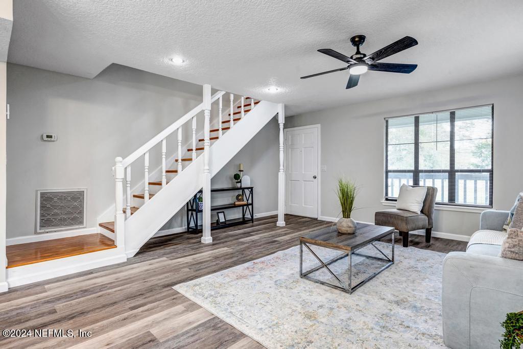 54197 Jeannie Road Callahan, FL 32011 - Photo 6 of 36 a living room with furniture and a ceiling fan
