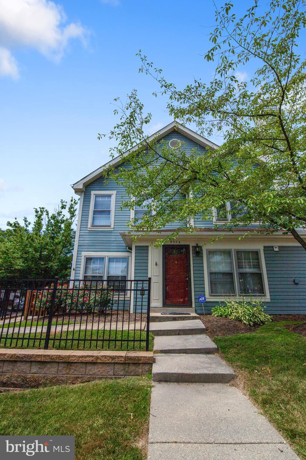 9304 Palmer Place, Unit 5 Laurel, MD 20708 - Photo 2 of 30 a front view of a house with a garden