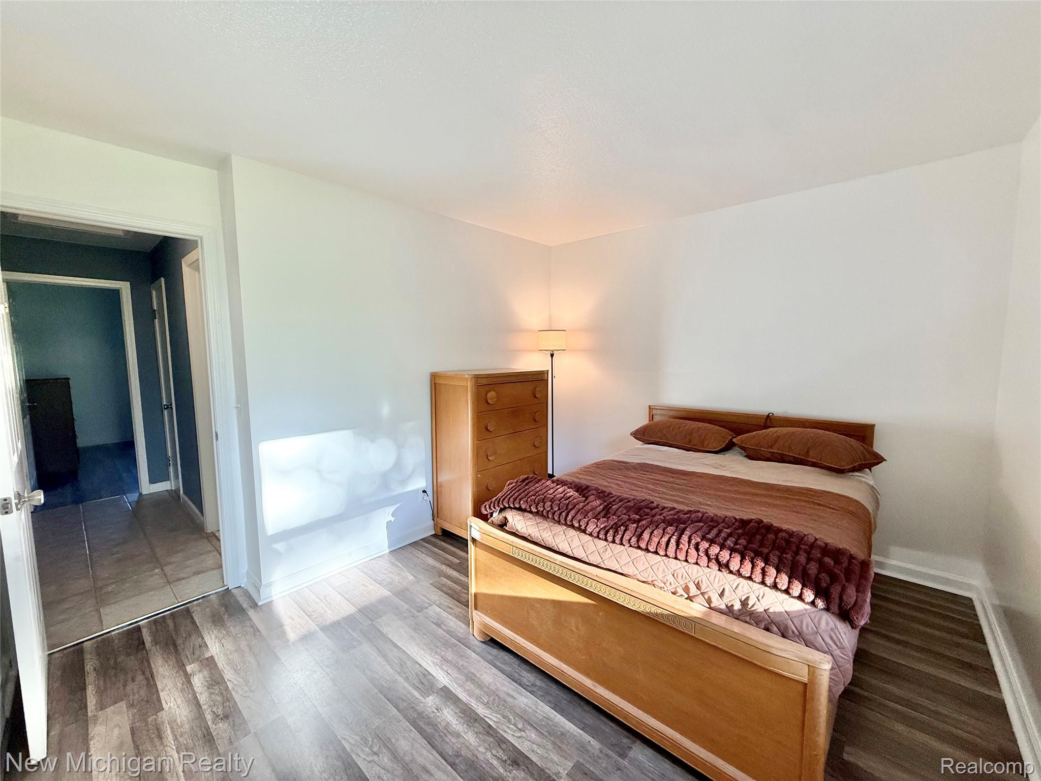 5288 Torrey Road Flint, MI 48507 - Photo 11 of 41 Bedroom featuring wood finished floors and baseboards
