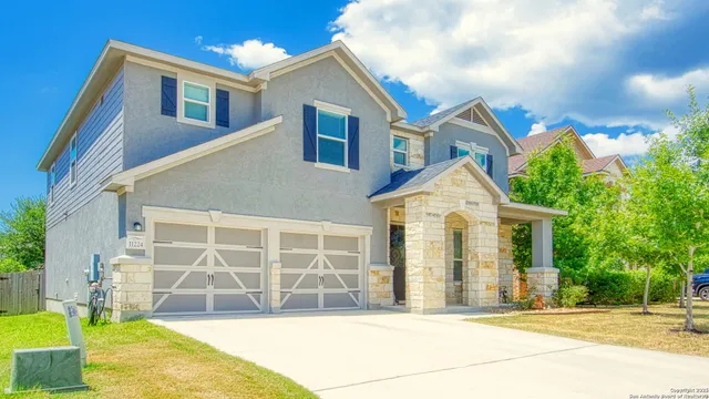 a front view of a house with a garden and yard