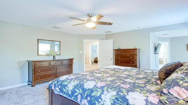 a bedroom with a large bed and a chandelier
