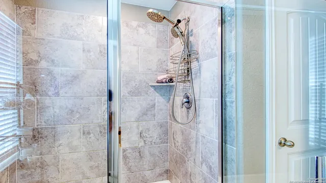 a view of walk in closet with clothes