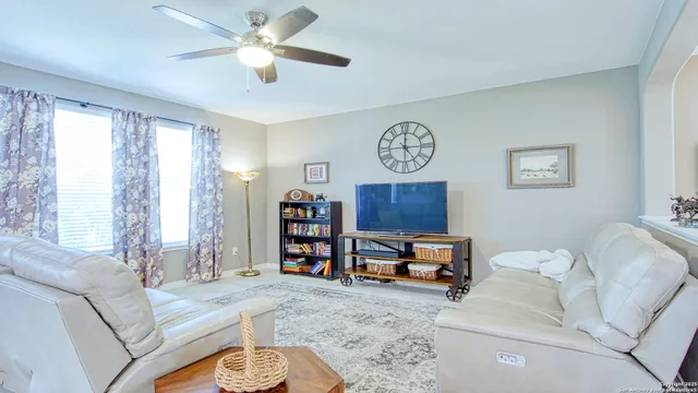 a bedroom with furniture and a large window