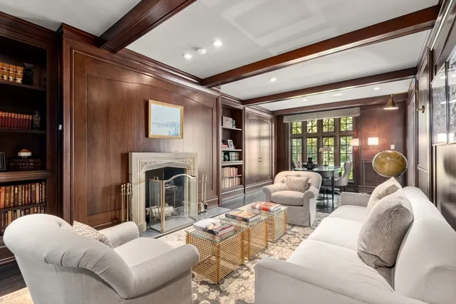 a living room with furniture a fireplace and a large window