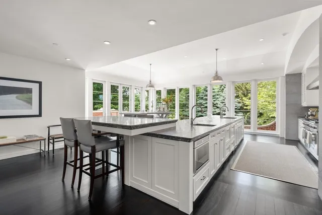 a kitchen with stainless steel appliances granite countertop counter space and dining table
