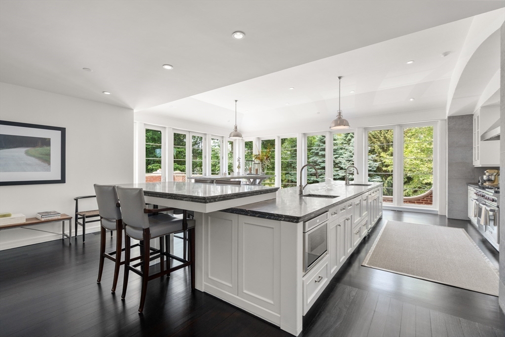 1014 Boylston Street Brookline, MA 02467 - Photo 16 of 38 a kitchen with stainless steel appliances granite countertop counter space and dining table