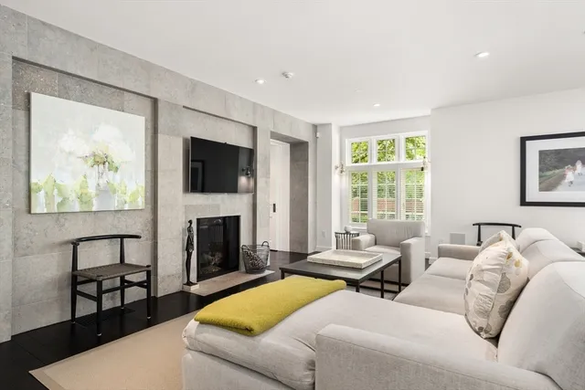 a living room with furniture fireplace and window