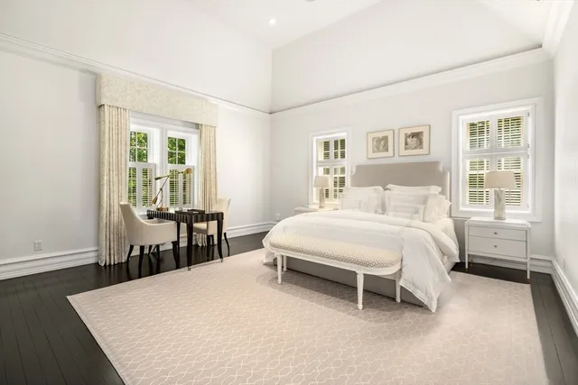 a bedroom with a bed table and a window