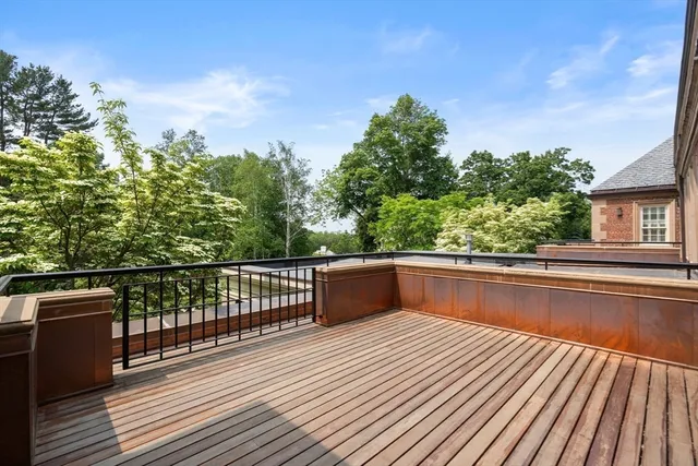 a view of balcony with wooden floor and fence