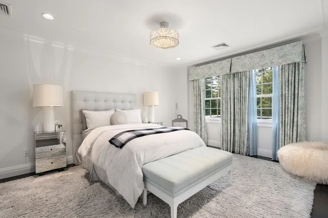 a bedroom with a bed and a lamp