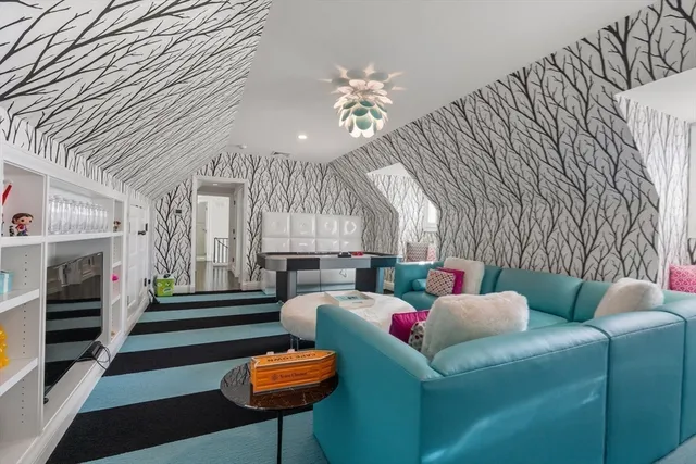 a living room with furniture a fireplace and a chandelier