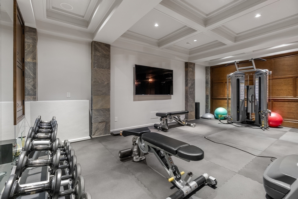 1014 Boylston Street Brookline, MA 02467 - Photo 33 of 38 a room with gym equipment and a flat screen tv