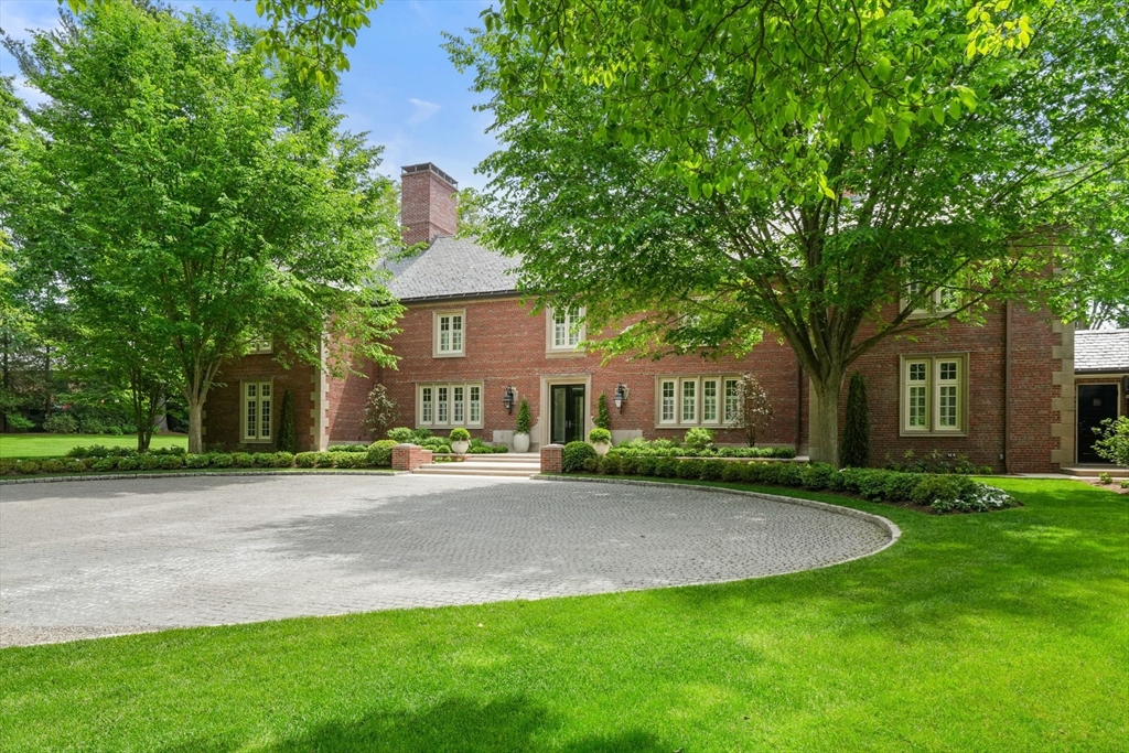 1014 Boylston Street Brookline, MA 02467 - Photo 6 of 38 a front view of a house with a garden and trees