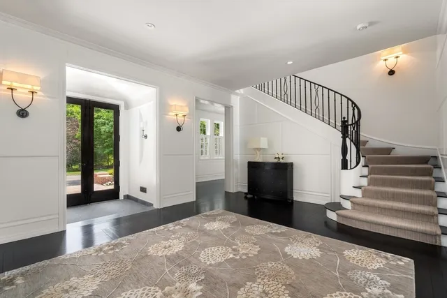 a view of entryway and hall with wooden floor