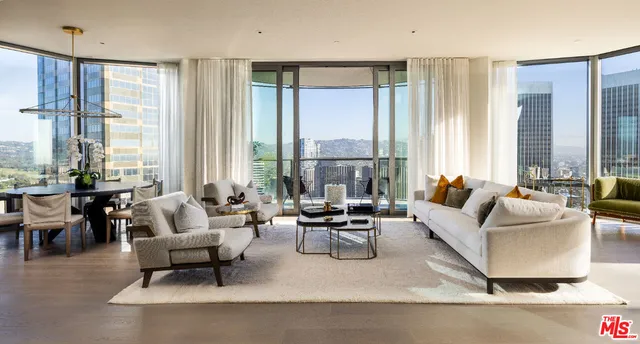 a living room with furniture and large windows