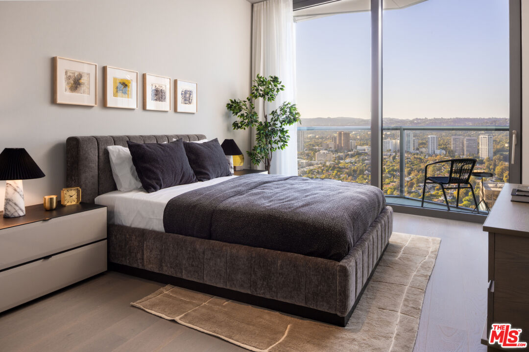 211 Elm Court, Unit 39B Los Angeles, CA 90067 - Photo 13 of 29 a living room with a balcony furniture and a large window