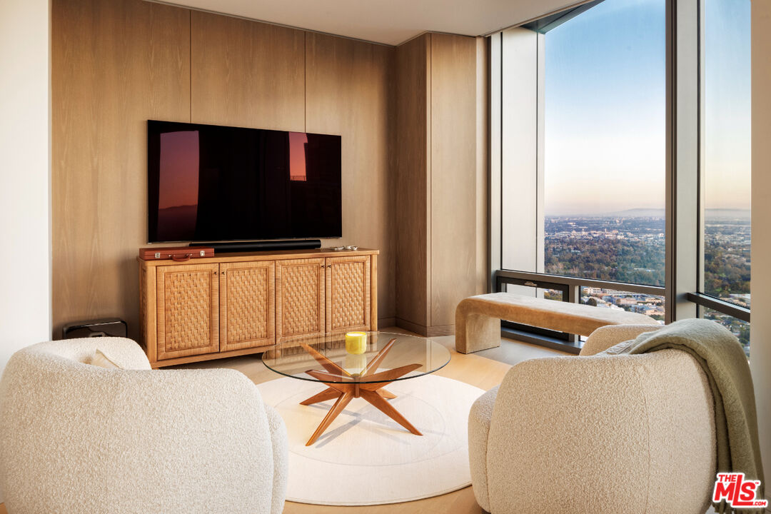 211 Elm Court, Unit 39B Los Angeles, CA 90067 - Photo 4 of 29 a living room with a flat screen tv and floor to ceiling window
