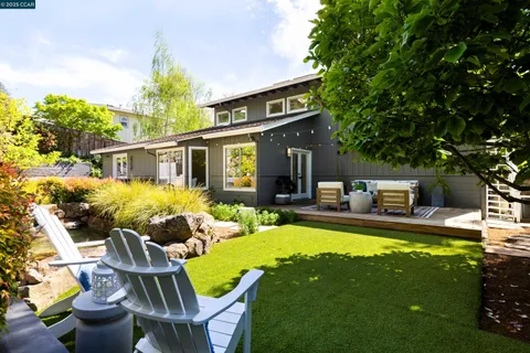 a view of a house with pool and chairs