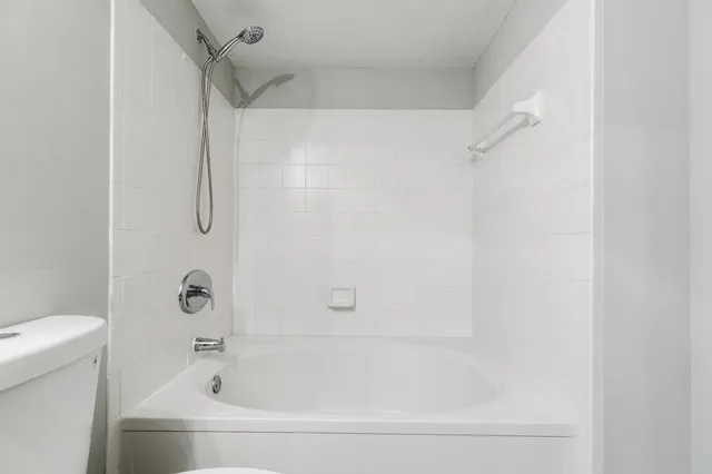 a white bath tub and a shower