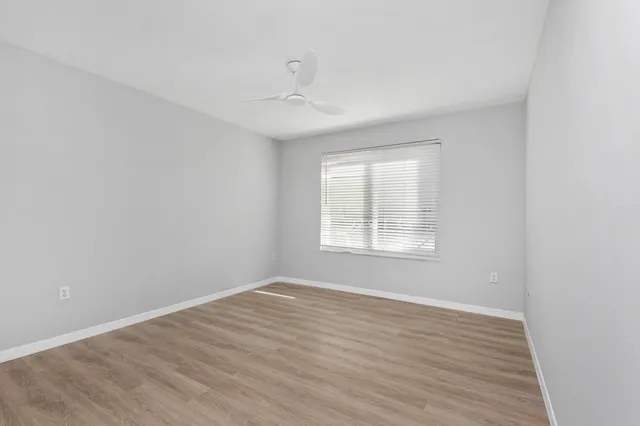 wooden floor in an empty room with a window