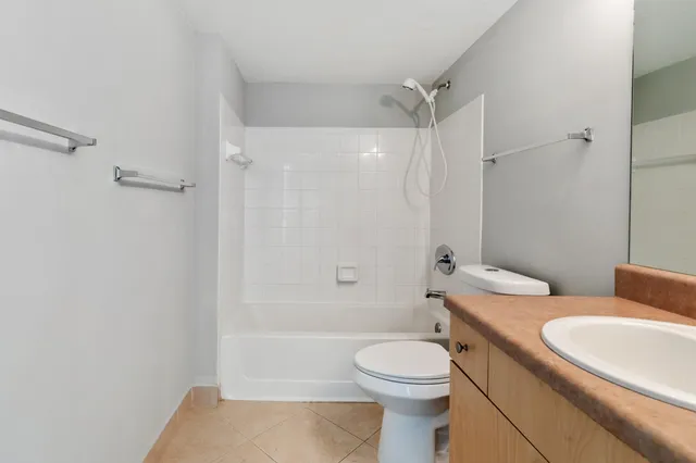 a bathroom with a toilet a sink and shower