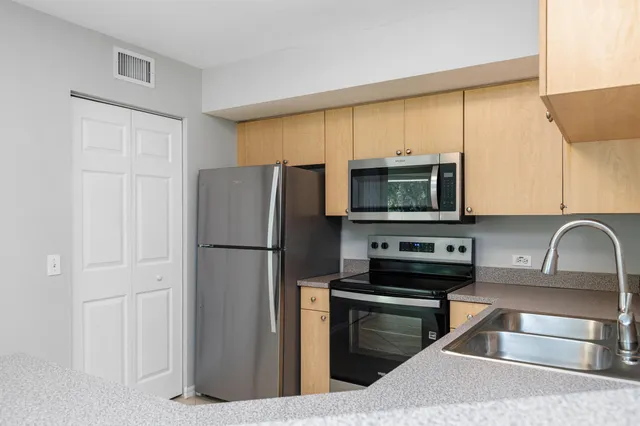 a kitchen with a refrigerator stove and microwave