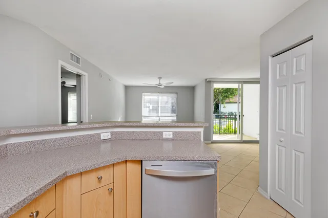 a kitchen with granite countertop a sink and a white cabinets