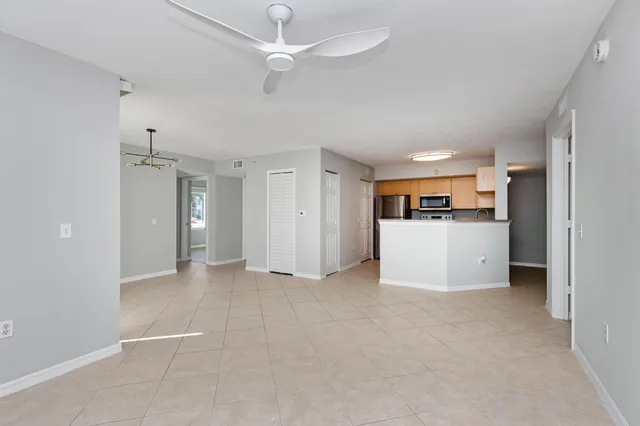 a view of a kitchen with a sink and a refrigerator