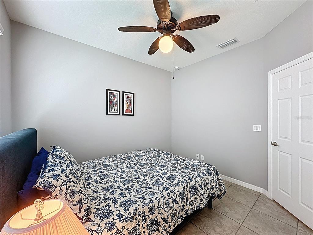 277 Silver Maple Road Groveland, FL 34736 - Photo 24 of 81 a bedroom with bed and a window