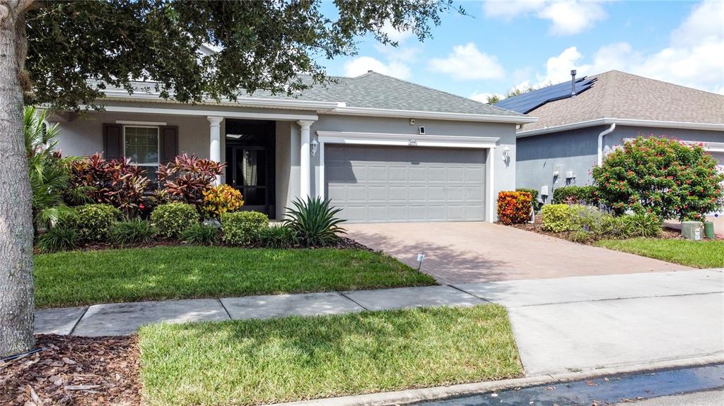 277 Silver Maple Road Groveland, FL 34736 - Photo 3 of 81 a front view of a house with garden