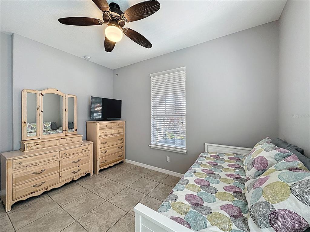 277 Silver Maple Road Groveland, FL 34736 - Photo 39 of 81 a bedroom with a bed and a chandelier