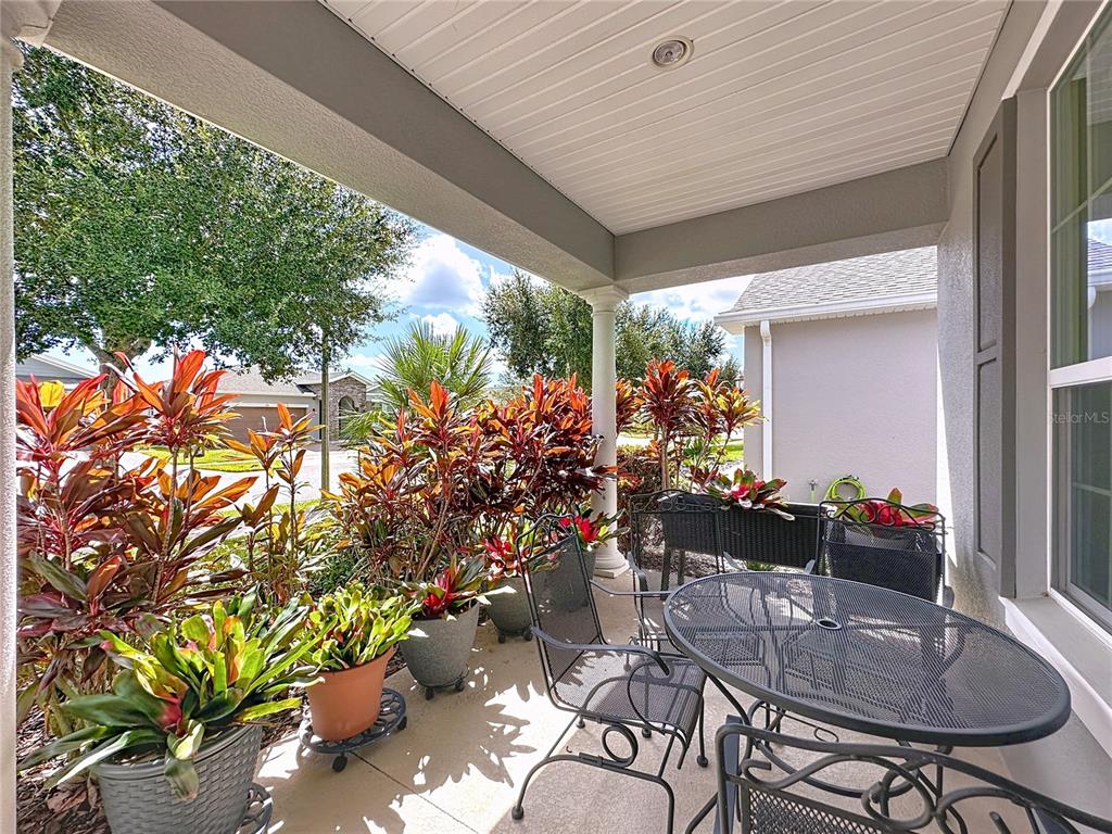 277 Silver Maple Road Groveland, FL 34736 - Photo 4 of 81 a outdoor dining space with furniture and potted plants