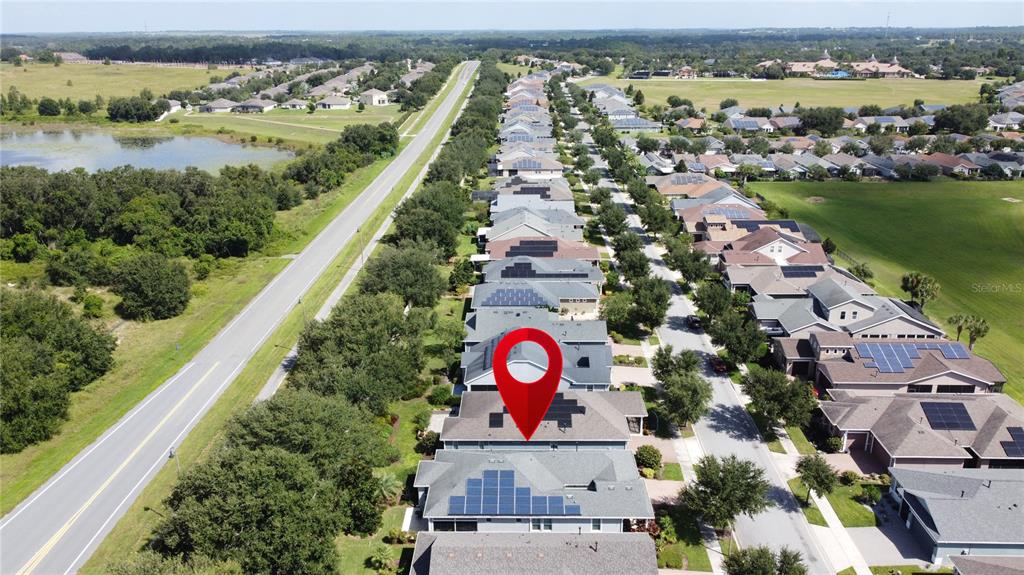 277 Silver Maple Road Groveland, FL 34736 - Photo 61 of 81 an aerial view of lake and residential houses with outdoor space