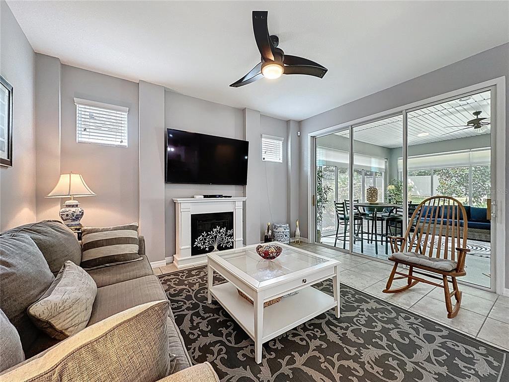 277 Silver Maple Road Groveland, FL 34736 - Photo 9 of 81 a living room with furniture a fireplace and a flat screen tv