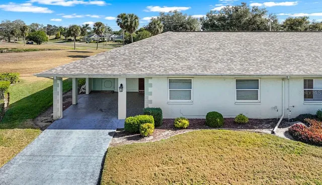 a aerial view of residential houses with outdoor space and ocean view