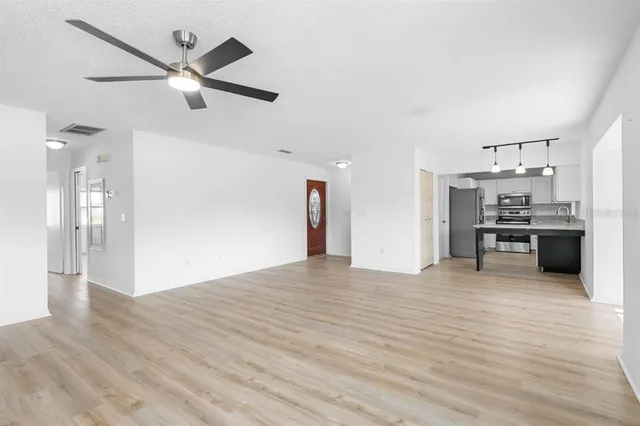 a view of a kitchen with a sink and a refrigerator