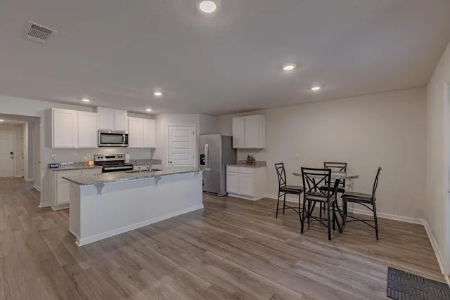 a kitchen with a table and chairs in it