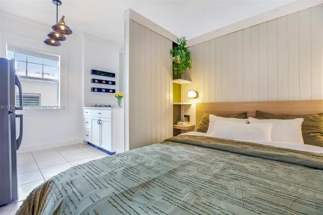 a bedroom with a bed dresser and a window